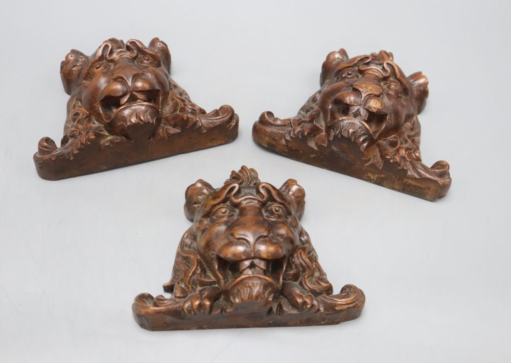 Three French carved walnut lions masks, width 17cm
